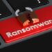 Ransomware red button on keyboard, 3D rendering
