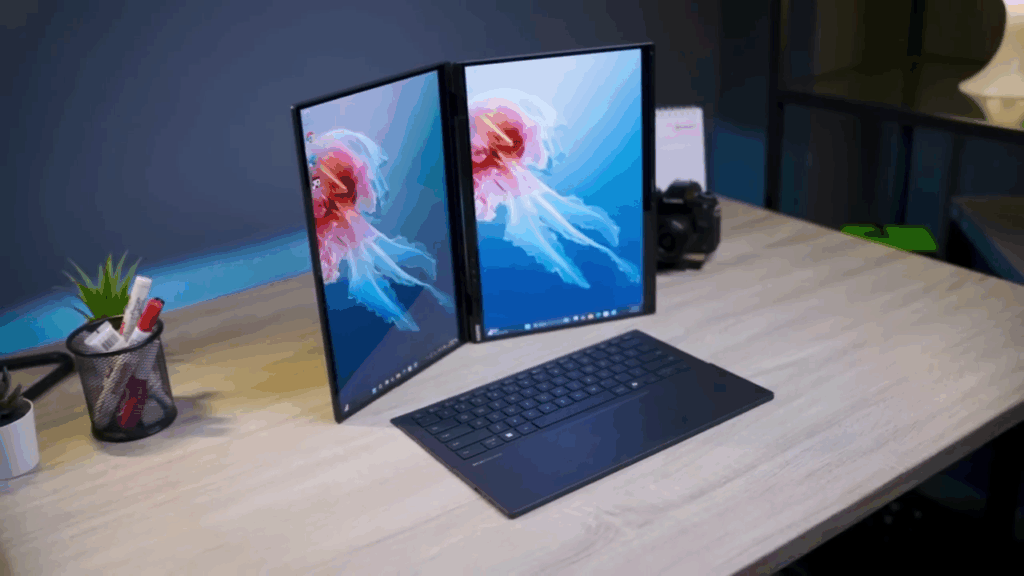 Desain revolusioner ASUS Zenbook DUO dengan dua layar terbuka berdampingan dan keyboard fisik yang dapat dilepas, menyoroti tantangan pada desain engsel dan papan ketiknya.