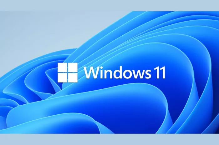Logo Windows 11 berwarna putih di atas latar belakang wallpaper biru bergelombang yang khas, merepresentasikan sistem operasi terbaru Microsoft.
