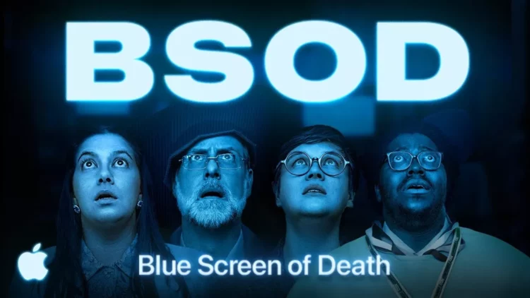 Empat orang menatap ke atas dengan ekspresi terkejut di bawah tulisan neon biru "BSOD", dengan logo Apple di sudut kiri bawah, menyindir Blue Screen of Death.