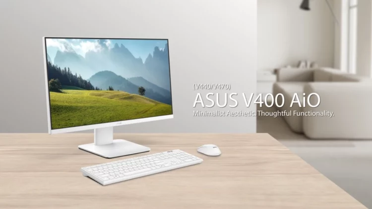 Sebuah ASUS All-in-One PC V440 berwarna putih diletakkan di atas meja kayu, menunjukkan desainnya yang estetik dan minimalis untuk ruang kerja modern.
