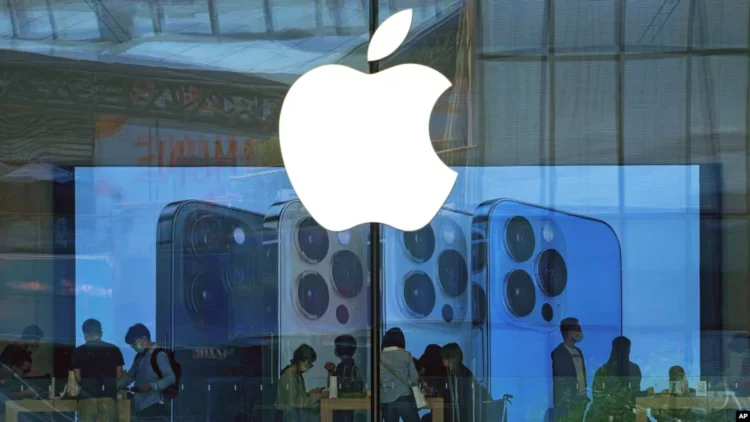 Logo Apple di jendela Apple Store sebagai ilustrasi berita Apple pindah pabrik iPhone dan Vision Pro untuk menghindari biaya perang dagang Rp17 T.