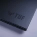 Logo TUF di bodi belakang laptop gaming ASUS TUF Gaming F16 (2025) yang sedang diulas.