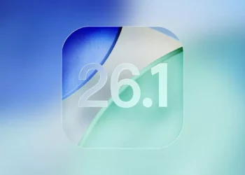 Logo visual angka "26.1" dengan desain glassmorphism di atas latar belakang blur gradasi biru dan hijau, merepresentasikan update sistem operasi iOS 26.1.