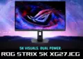 Tampilan depan monitor gaming Asus ROG Strix XG27JCG yang menampilkan wallpaper galaksi tajam dengan teks promosi 5K Visuals Dual Power.