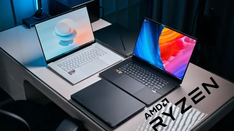 Setup studio menampilkan rekomendasi laptop AMD Ryzen terbaik 2025, termasuk Asus Zenbook putih dan Razer Blade hitam dengan logo AMD Ryzen.