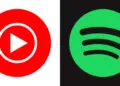 Ikon aplikasi YouTube Music merah dan Spotify hijau dalam bentuk lingkaran yang kontras.