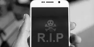 Layar smartphone menampilkan simbol tengkorak dan tulisan RIP sebagai ilustrasi HP mati total.