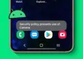 Munculnya pesan error Security policy prevents use of camera pada layar HP Android dengan ikon robot hijau.