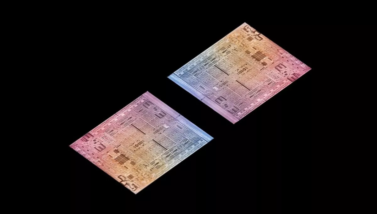 Foto makro detail sirkuit internal atau die shot dari chipset Apple M5 Pro dengan gradasi warna pelangi.