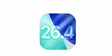 Ikon aplikasi atau logo sistem operasi iOS 26.4 dengan desain gradasi warna biru dan hijau yang modern.