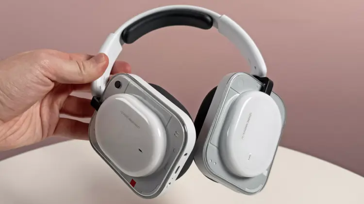 Seseorang sedang memegang Nothing Headphone (a) varian warna putih yang memiliki desain earcup transparan yang ikonik.