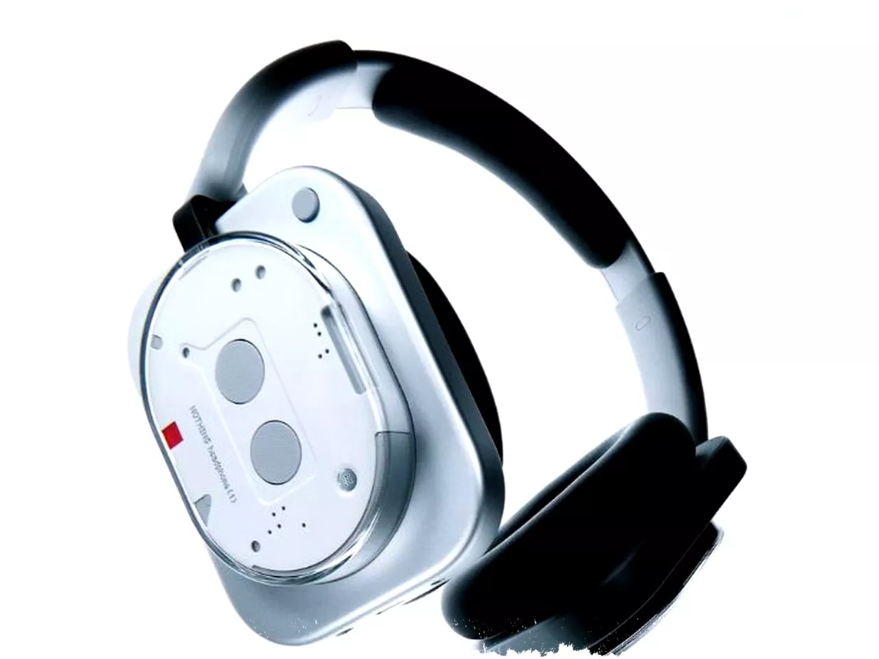 Tampilan sudut miring Nothing Headphone (a) yang memperlihatkan detail headband hitam dan modul earcup putih minimalis.