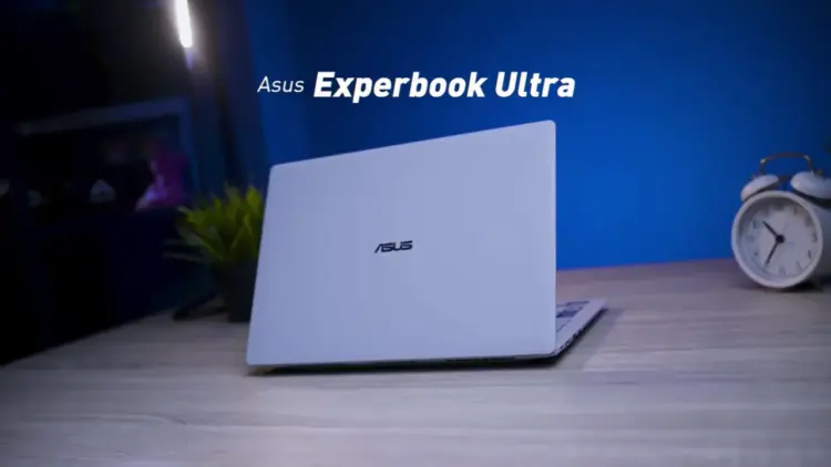ASUS ExpertBook Ultra warna Morn Grey berbahan Magnesium Alloy dengan desain tipis dan premium di atas meja kerja.