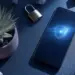 Smartphone menampilkan logo perisai bercahaya di samping gembok besi sebagai simbol privasi online yang aman.