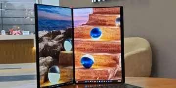 Tampilan penuh laptop ASUS Zenbook DUO 2026 dalam mode dua layar aktif menggunakan penopang kickstand terintegrasi.