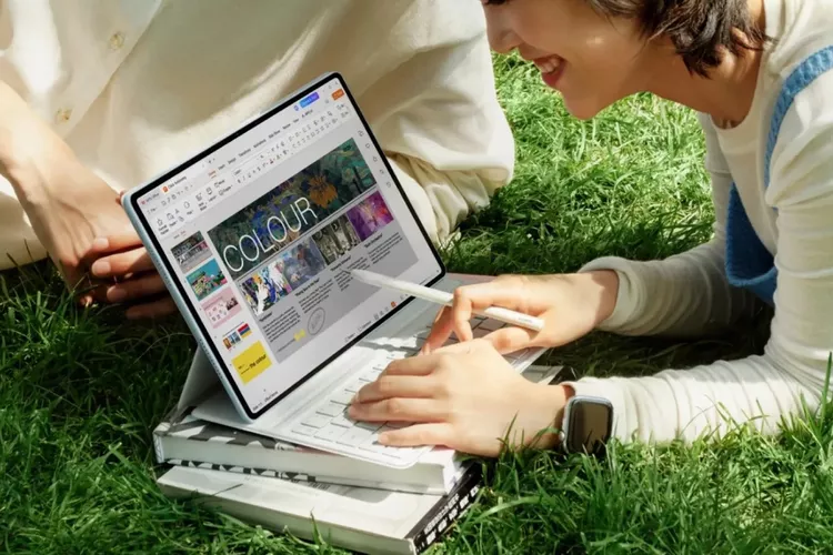 Dua orang sedang menggunakan tablet Huawei MatePad Air 2026 dengan stylus pen untuk bekerja di area taman terbuka