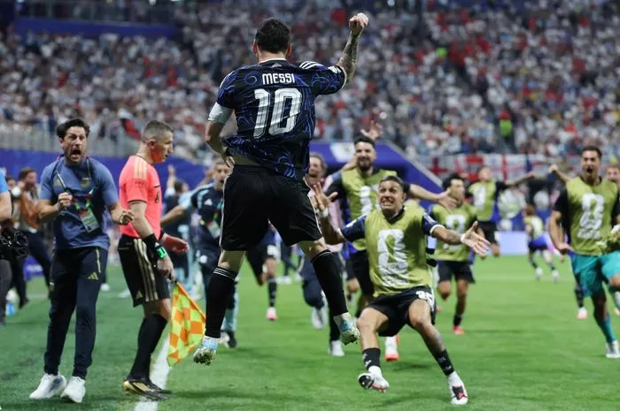 Lionel Messi bernomor punggung 10 melompat merayakan gol bersama rekan setimnya di timnas Argentina.