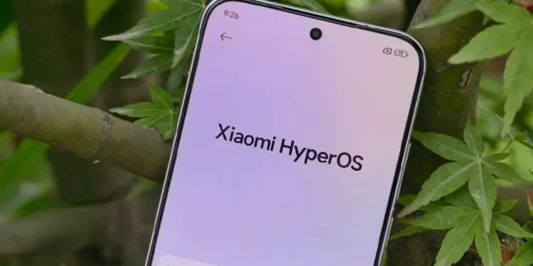 Tampilan layar HP Xiaomi menunjukkan logo Xiaomi HyperOS di menu pengaturan dengan latar belakang daun hijau.
