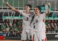 Dua pemain Timnas Indonesia bernomor punggung 9 dan 19 merayakan gol dengan mengepalkan tangan gembira.