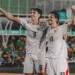 Dua pemain Timnas Indonesia bernomor punggung 9 dan 19 merayakan gol dengan mengepalkan tangan gembira.