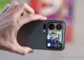 Seseorang memegang Xiaomi 18 Pro Max secara horizontal untuk mengambil foto selfie, menampilkan pratinjau wajah pria tersenyum di layar sekunder belakang ponsel.