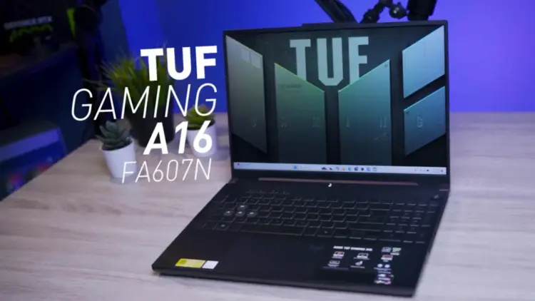 Tampilan depan laptop gaming ASUS TUF A16 FA607N dalam posisi terbuka di atas meja kerja dengan latar cahaya biru studio.