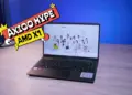 Laptop 5 jutaan terbaik 2026 Axioo Hype AMD X1 tampak depan di atas meja kayu dengan layar Full HD menampilkan wallpaper JKT48.