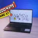 Laptop 5 jutaan terbaik 2026 Axioo Hype AMD X1 tampak depan di atas meja kayu dengan layar Full HD menampilkan wallpaper JKT48.