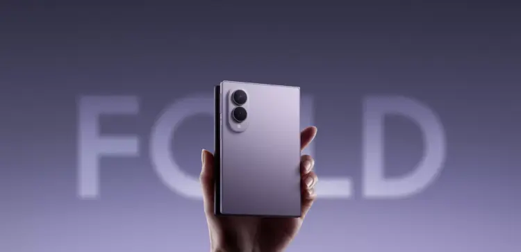 Tangan memegang smartphone lipat Samsung Galaxy Z Fold 8 warna ungu dalam kondisi terlipat