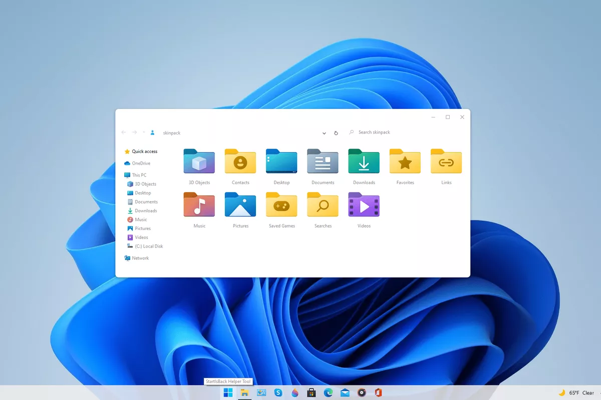 Tampilan antarmuka File Explorer Windows 11 dengan wallpaper biru khas Microsoft.