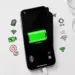 Layar iPhone menampilkan indikator baterai hijau penuh dikelilingi ikon pengaturan konektivitas seperti Wi-Fi dan lokasi.
