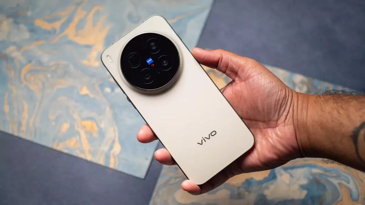 Seseorang memegang bodi belakang Vivo X500 Pro yang menampilkan modul kamera ZEISS.