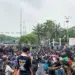 Peserta demo Jakarta duduk tertib di sekitar jalanan dekat gerbang gedung DPR RI.