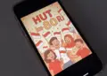 Desain poster HUT RI ke-80 bergaya ilustrasi kartun meriah yang ditampilkan pada layar ponsel pintar.