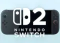 Konsol genggam Nintendo Switch 2 warna hitam dengan logo resmi di bagian layar.