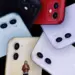 Berbagai pilihan warna unit iPhone bekas dual camera seperti merah, ungu, kuning, dan hijau pastel tampak dari bagian belakang.