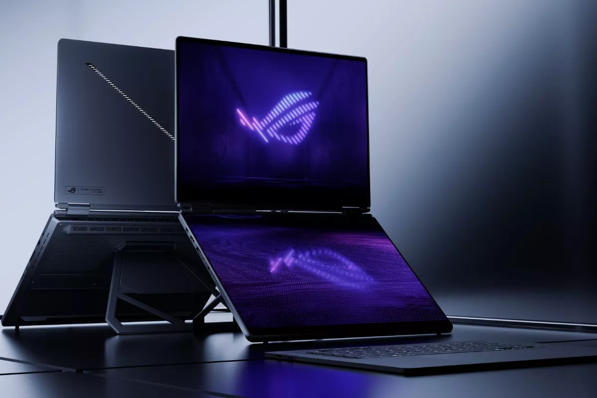 Laptop gaming dual screen ASUS ROG Zephyrus Duo dengan pencahayaan logo ROG bernuansa ungu modern.