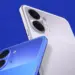 Tampilan sudut kamera dua smartphone budget varian warna biru dan putih perak dengan latar belakang biru.