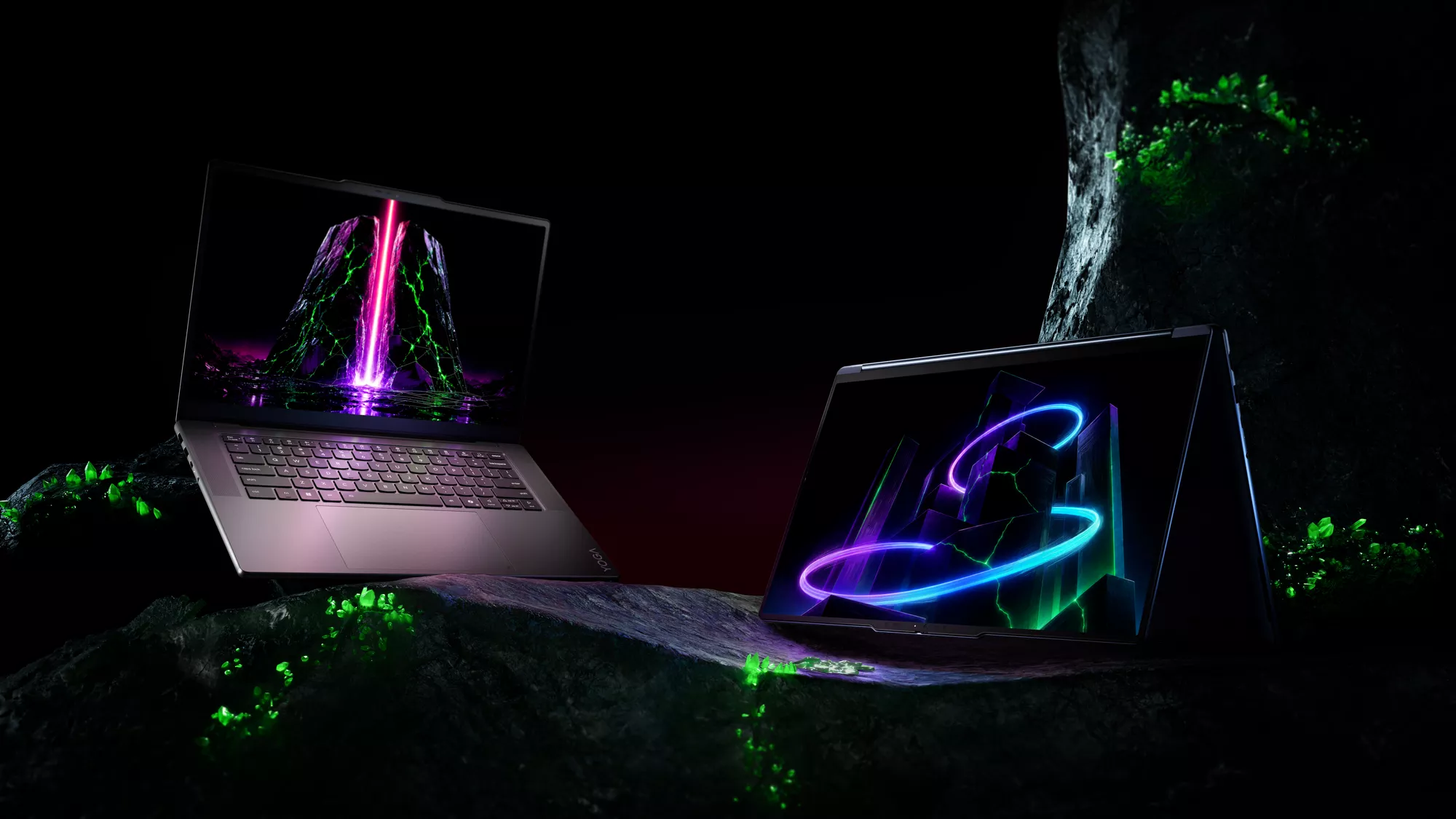 Laptop Lenovo Yoga Pro dan Lenovo Yoga 2-in-1 dengan layar visual neon futuristik berlatar batu kristal hijau.