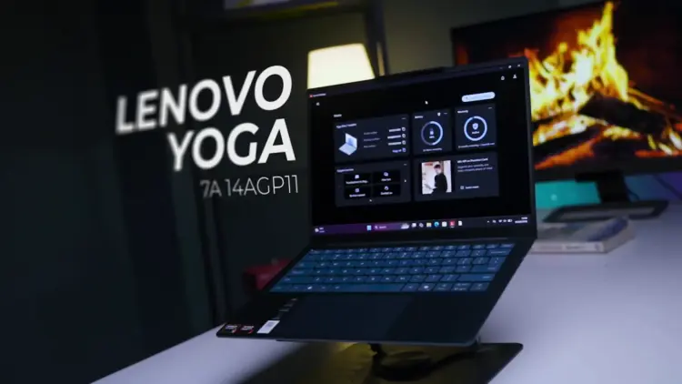 Laptop Lenovo Yoga Slim 7a 14AGP11 berwarna gelap diletakkan di atas stand laptop meja kerja studio.