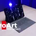 Laptop hibrida detachable ASUS ProArt PZ14 berwarna abu-abu tua di atas meja kayu dengan pencahayaan studio biru cobalt.